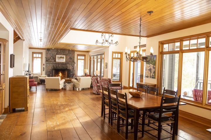 Great room with stone fireplace and dining table
